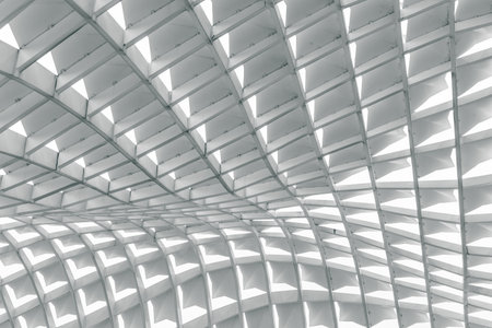 Modern architectural ceiling with geometric patterns and repetitive shapes.の写真素材