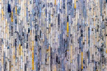 Colorful stone wall with vertical patterns and textures.の写真素材