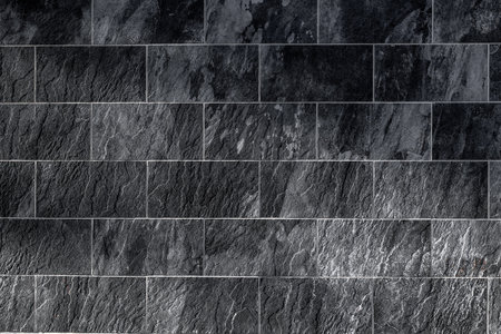 Dark slate wall texture with rectangular tile pattern.の写真素材