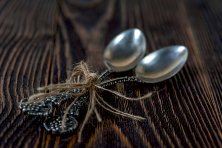 Two silver spoons on the rustic backgroundの写真素材