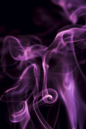 Motion of purple smoke on black backgroundの写真素材