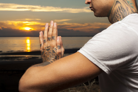 Cropped shot of male hands in meditation position. Yoga practice outdoors.の写真素材