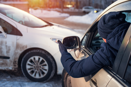 Male driver looking at scene of car crashの写真素材