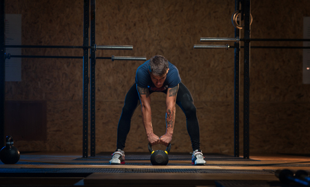 Male athlete doing exercises with kettlebellの写真素材
