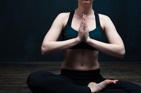 Relaxed young woman doing yoga meditationの写真素材