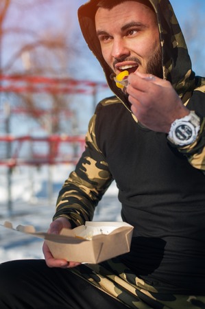 Male adult eating healthy food after workoutの写真素材