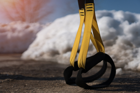 Fitness straps on background of snowの写真素材