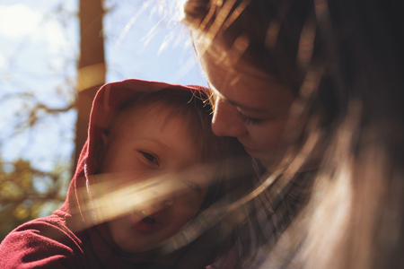 Portrait of young mom hugging her little sonの写真素材