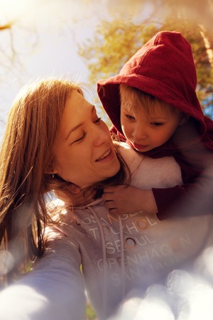 Portrait of young mom playing with her little sonの写真素材