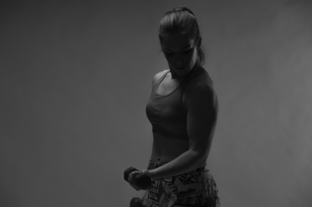 Fit girl doing biceps exercise with dumbbellの写真素材
