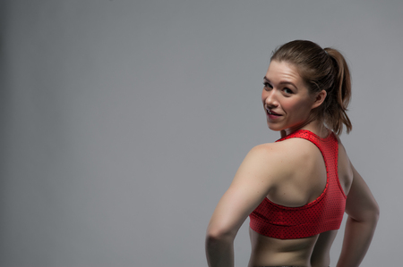 Portrait of young sporty woman posing in studioの写真素材