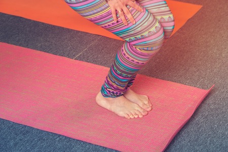 Closeup of female adult practicing yoga on matの写真素材