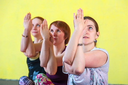 Three middle aged women in yoga sessionの写真素材