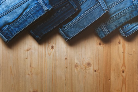 Blue denim jeans on wooden table.の写真素材