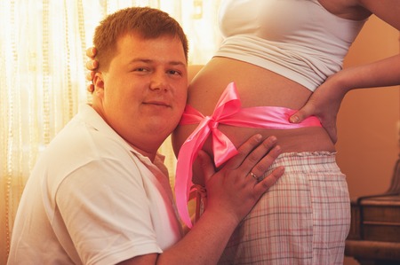 Young happy couple expecting baby