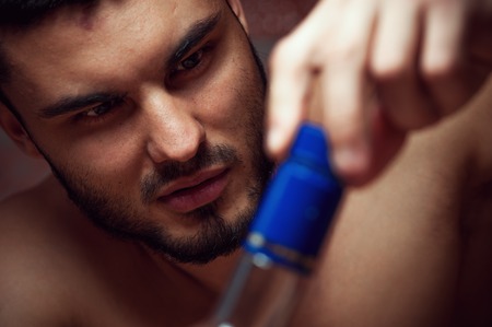 Male adult drinkinga alcohol at homeの写真素材