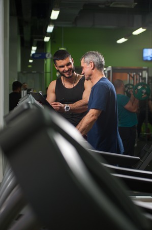 Smiling personal trainer working with senior manの写真素材