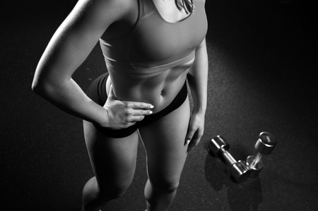 Cropped shot of fitness female posing in gymの写真素材