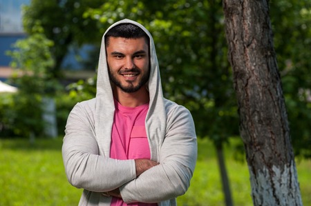 Portrait of smiling young man posing in park