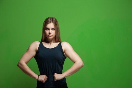 Fit young woman showing musclesの写真素材