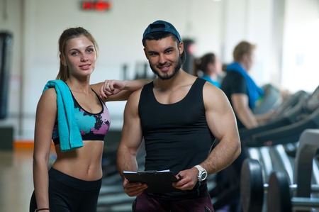 Young woman and coach looking at the cameraの写真素材