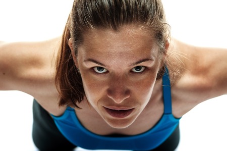 Portrait of strong confident woman doing push upsの写真素材