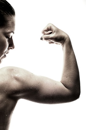 Fitness female showing biceps muscles