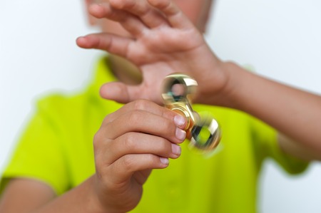 Closeup of tween boy playing with fidget spinnerの写真素材