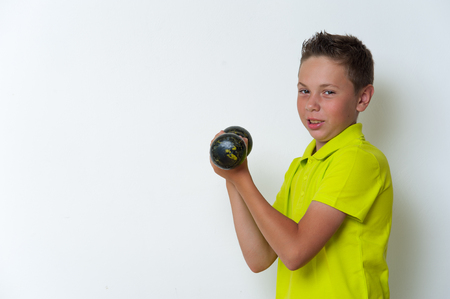 Portrait of tween fit boy with dumbbellの写真素材