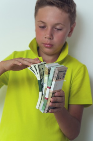 Tween boy counting dollar billsの写真素材