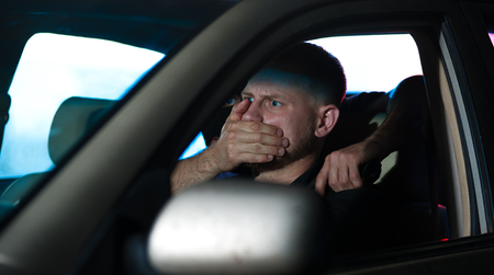 Car thief threatening driver with the gunの写真素材