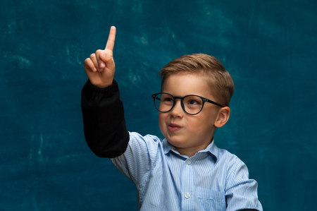 Cute boy imitating office worker or businesspersonの写真素材