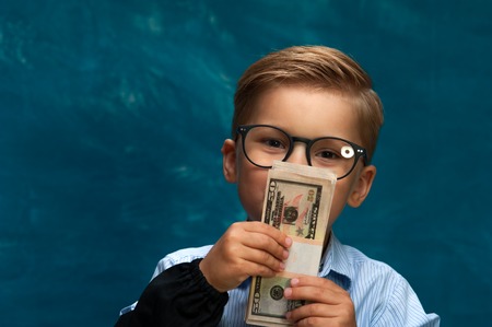 Fashionable business child counting moneyの写真素材