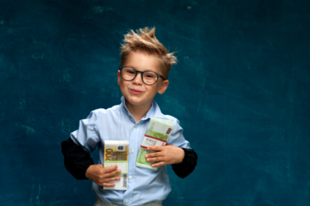 Smiling successful business child with cashの写真素材