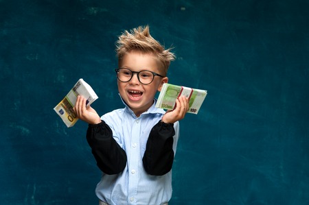 Portrait of funny stylish boy with money in handsの写真素材
