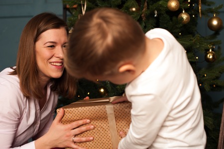 Happy smiling family decorating Christmas treeの写真素材