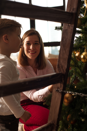 Happy smiling family decorating Christmas treeの写真素材