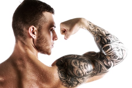 Handsome fitness model showing biceps musclesの写真素材