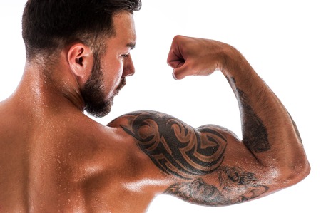 Handsome fitness model showing biceps musclesの写真素材