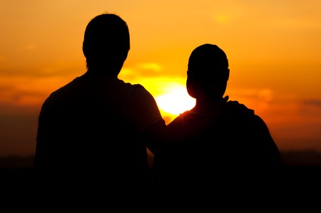 Two men enjoying sunset time togetherの写真素材