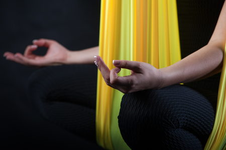 Girl practicing fly yoga, studio shot.の写真素材