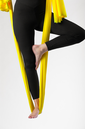 Cropped shot of female practicing aerial yogaの写真素材