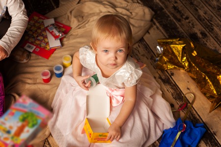 Adorable toddler girl next to Christmas treeの写真素材