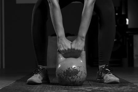 Female athlete preparing for kettlebell trainingの写真素材