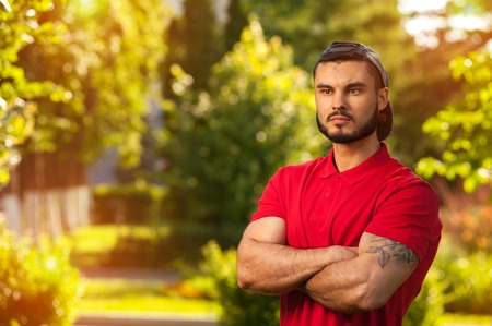 Outdoors portrait of young man in summer parkの写真素材