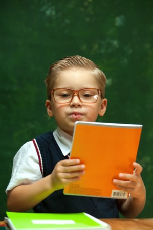 Cute positive little boy with glassesの写真素材