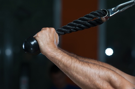 Hands of young man exercising in the gymの写真素材