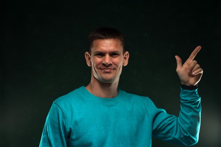 Portrait of positive man in blue sweatshirt