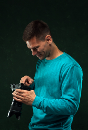 Male photographer setting the cameraの写真素材