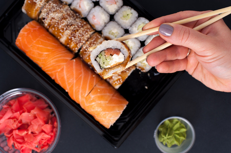 Sushi rolls set with wasabi, ginger and chopsticksの写真素材